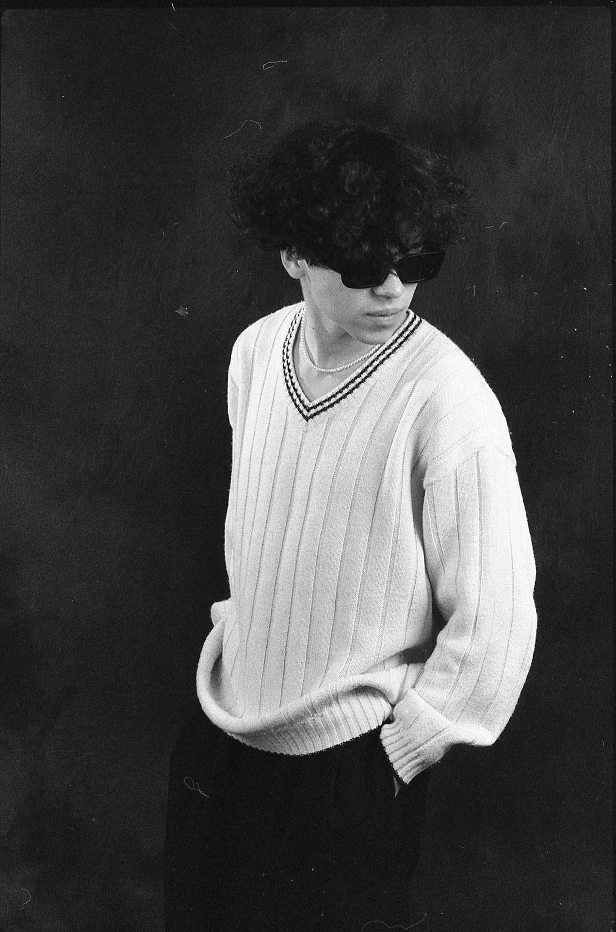 a black and white photo of a woman in a sweater